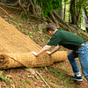 Experts at HEIGER Australia unrolling coir geotextiles on eroded slopes to prevent sediment run off